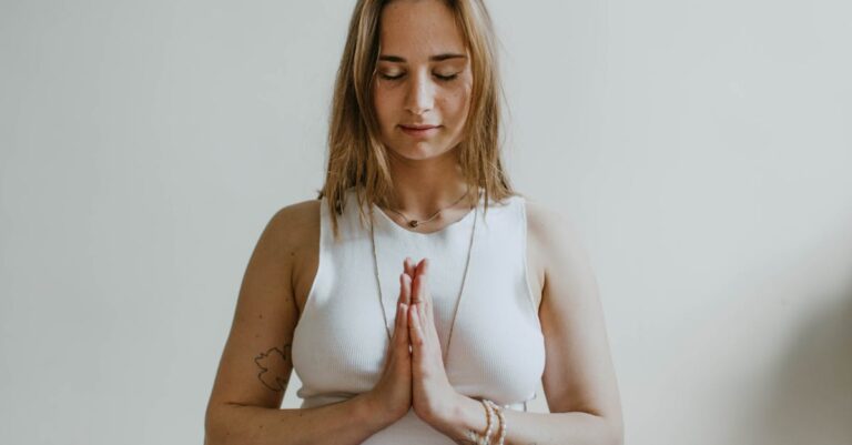 A serene image of a woman practicing meditation indoors, promoting mindfulness and wellbeing.